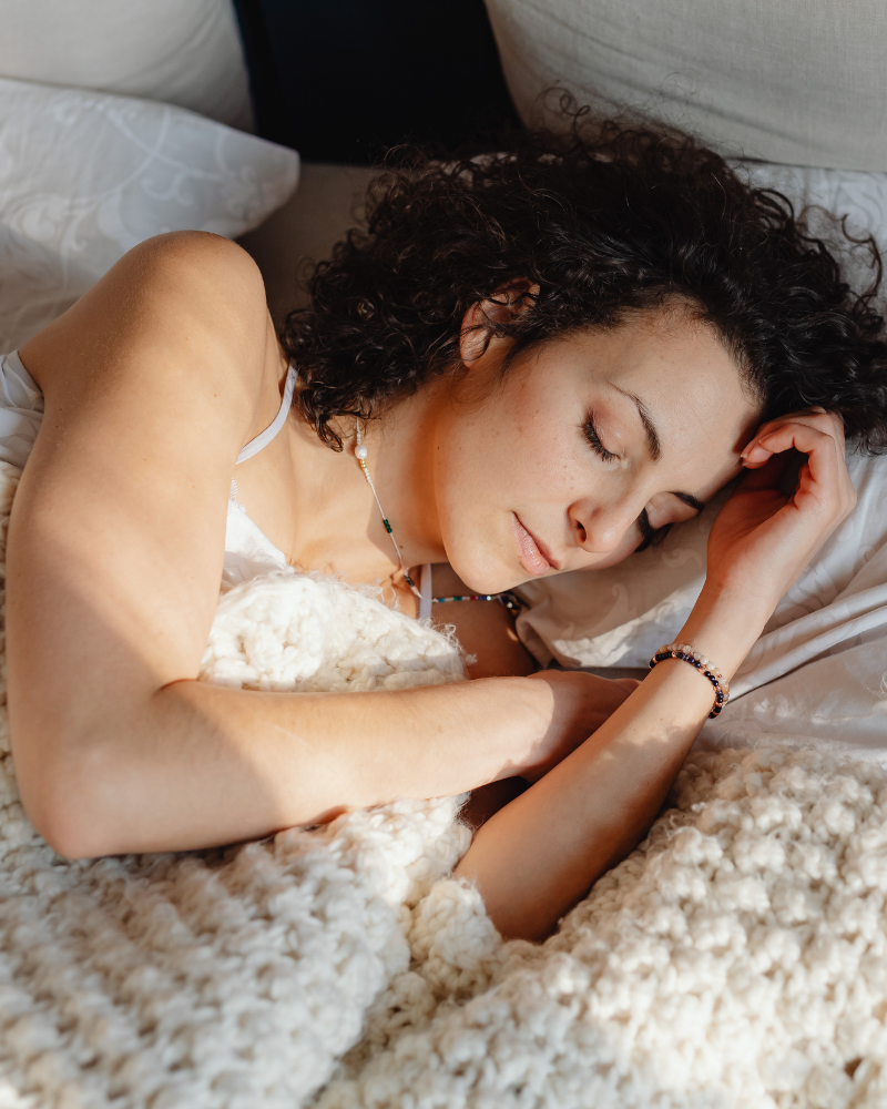 A woman sleeping with clear aligner in her mouth.